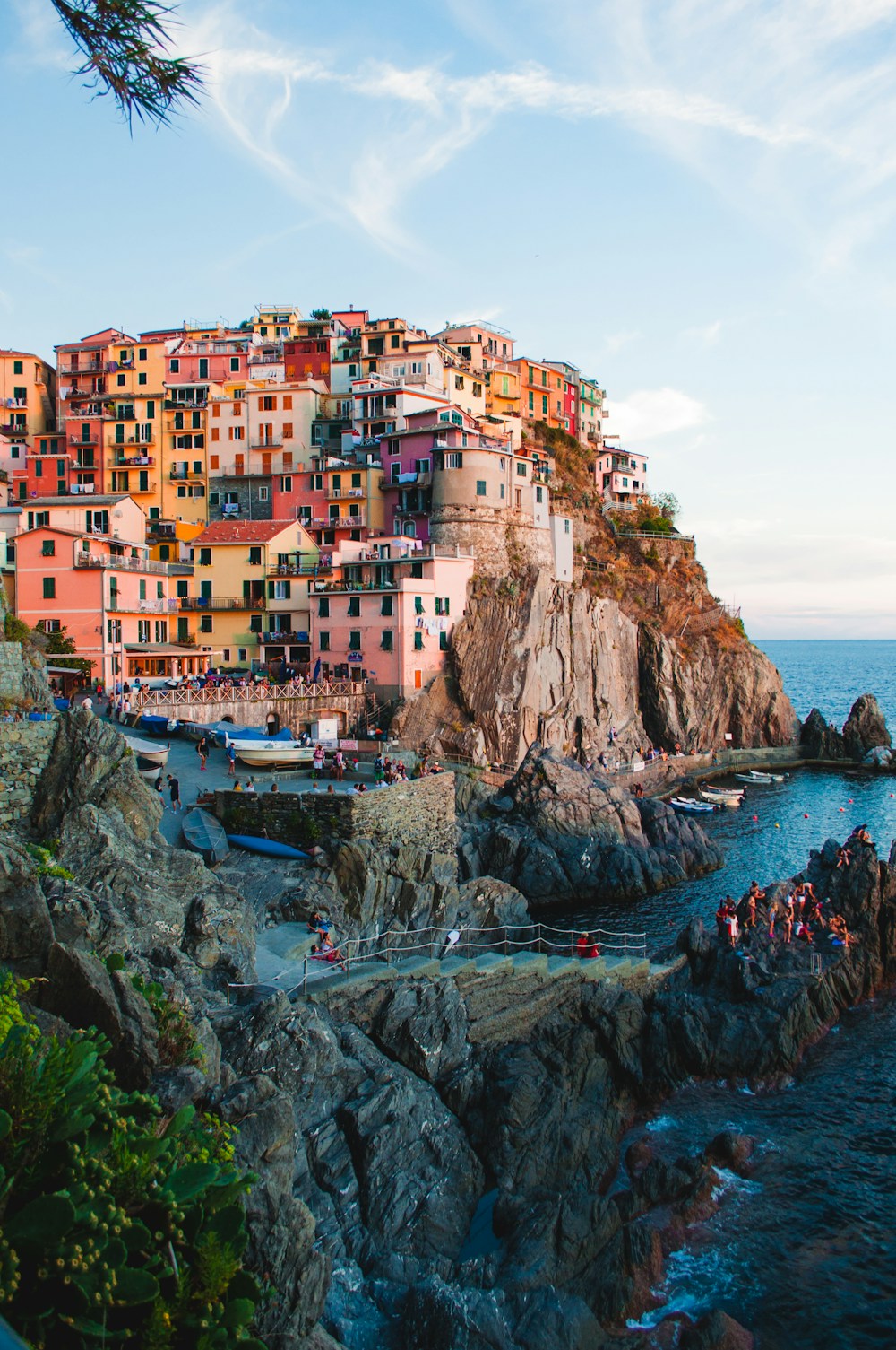 Sunlit coastal village beside blue water